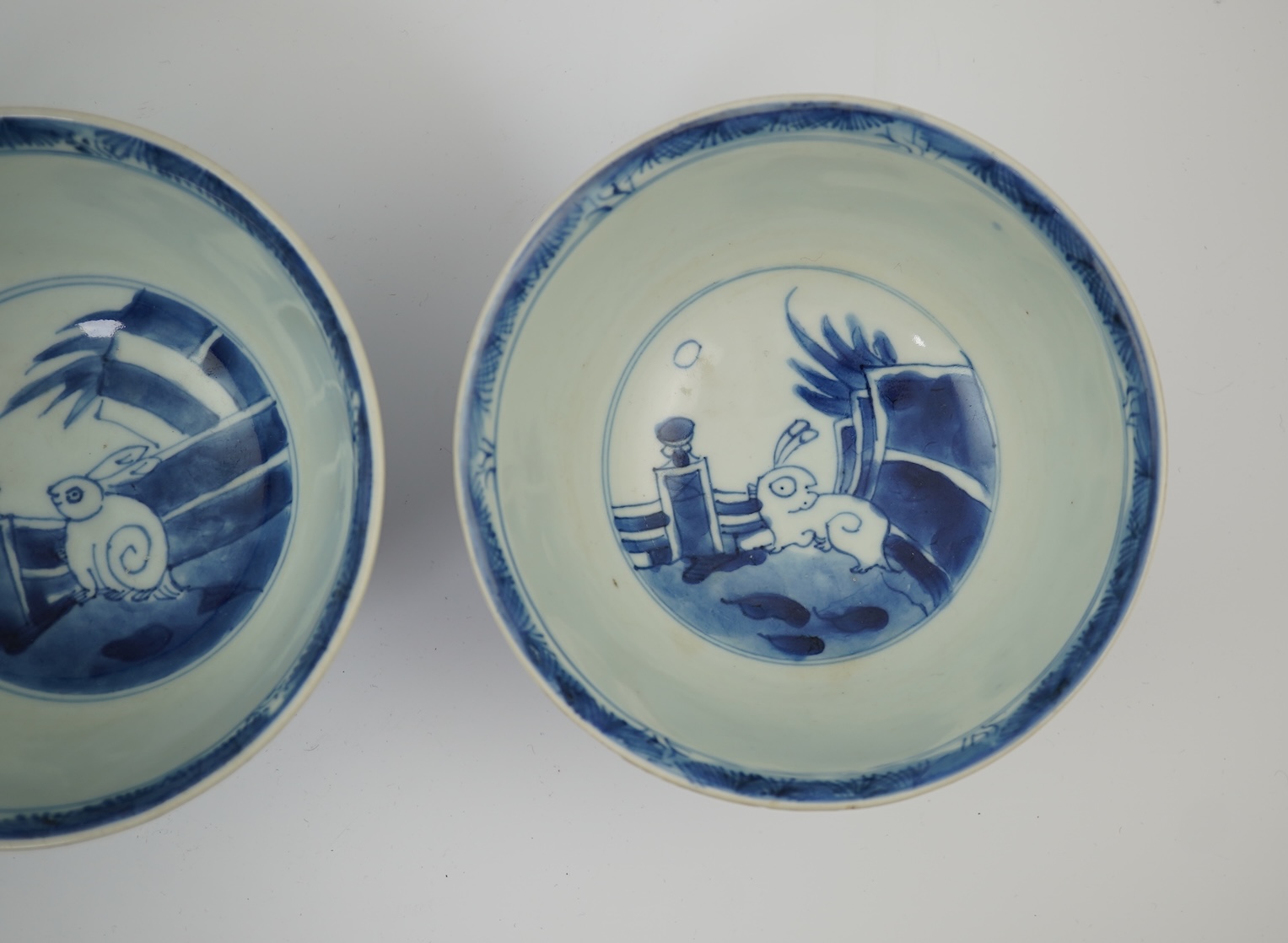 A pair of Chinese Transitional blue and white 'mythical beasts' bowls, early Kangxi period